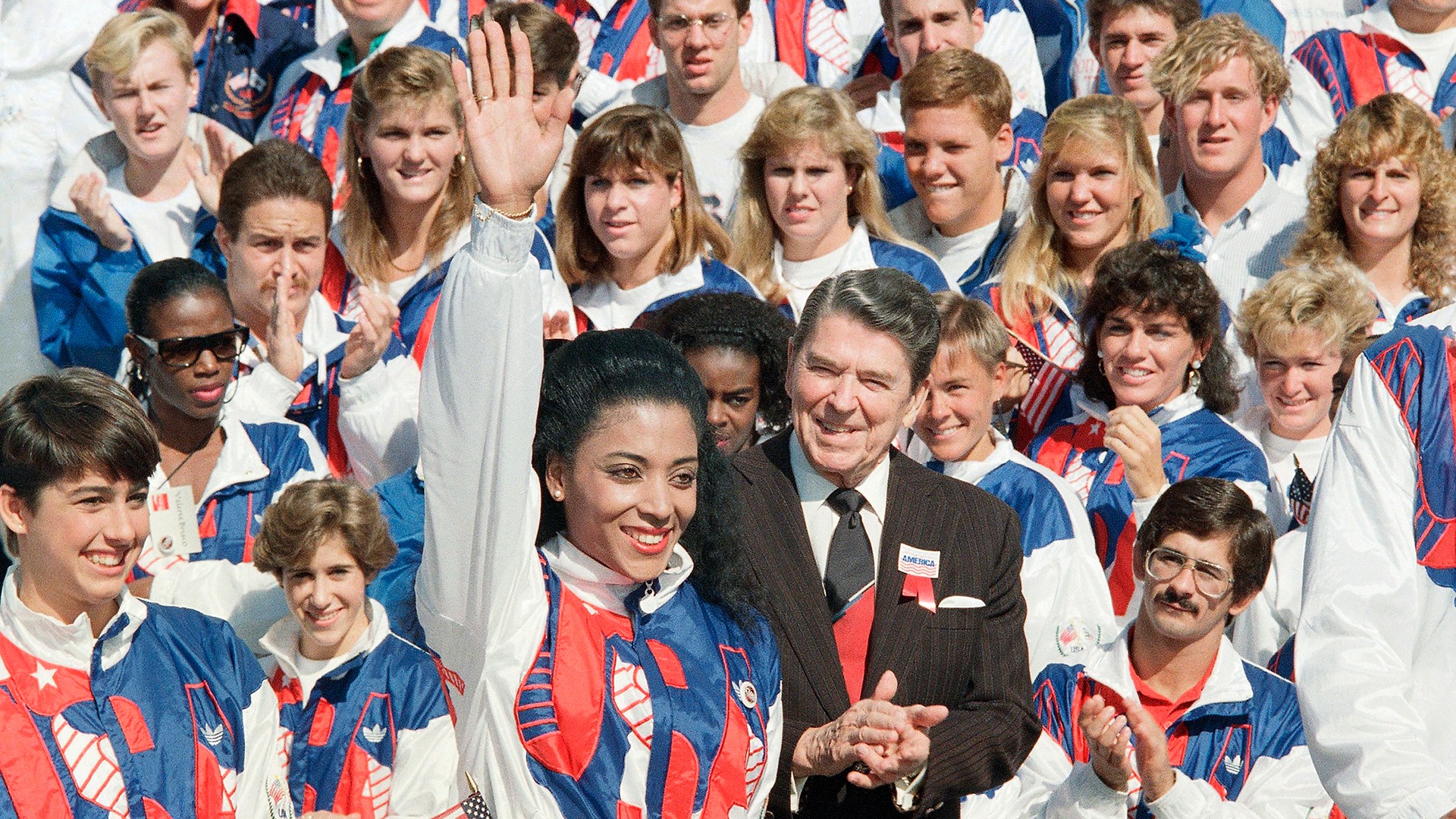 Olympic gold medalist Florence Griffith Joyner is applauded by President Ronald Reagan