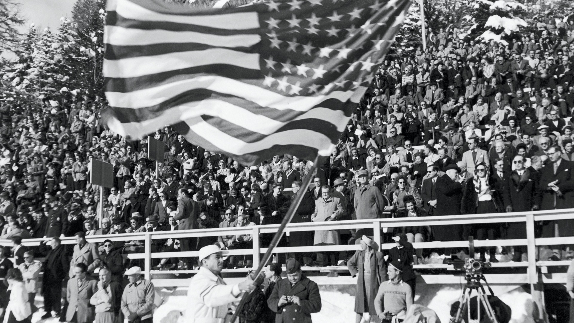 Jack Heaton waves the U.S. flag as he parades past spectators