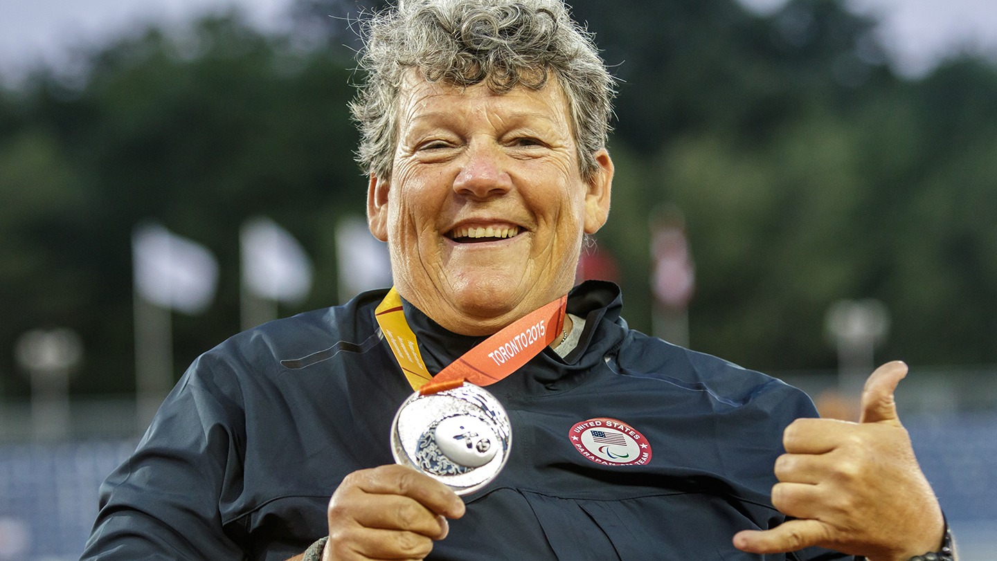 Angela Madsen proudly displays her medal