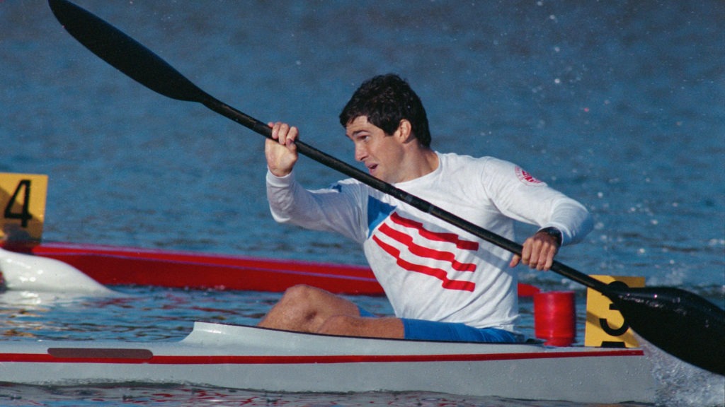 Greg Barton paddles on smooth water