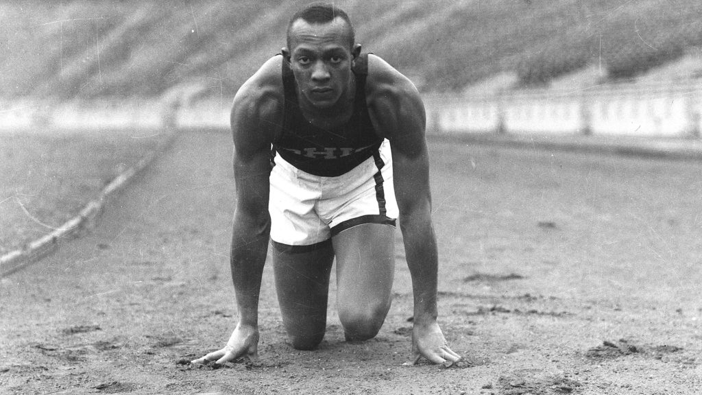 Jesse Owens poses in a crouch on the track at Ohio State