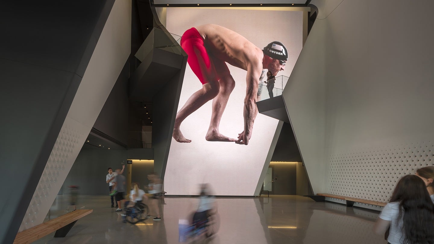 Paralympic swimming champion Brad Snyder is featured on the 40-foot LED wall in the Museum atrium.
