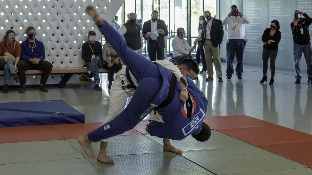 Two judoka show off maneuvers during a demonstration in the Museum atrium.