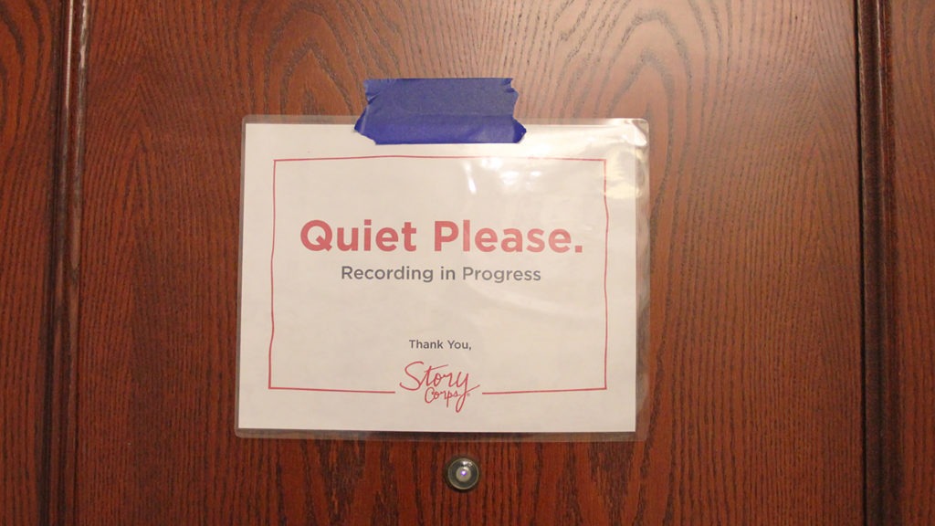 A sign on the outside of a door asks for "Quiet please" while a StoryCorps session is being recorded