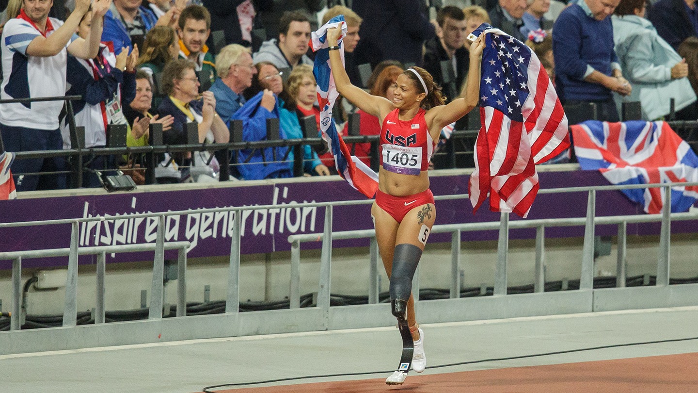 April Holmes drapes an American flag over her shoulders