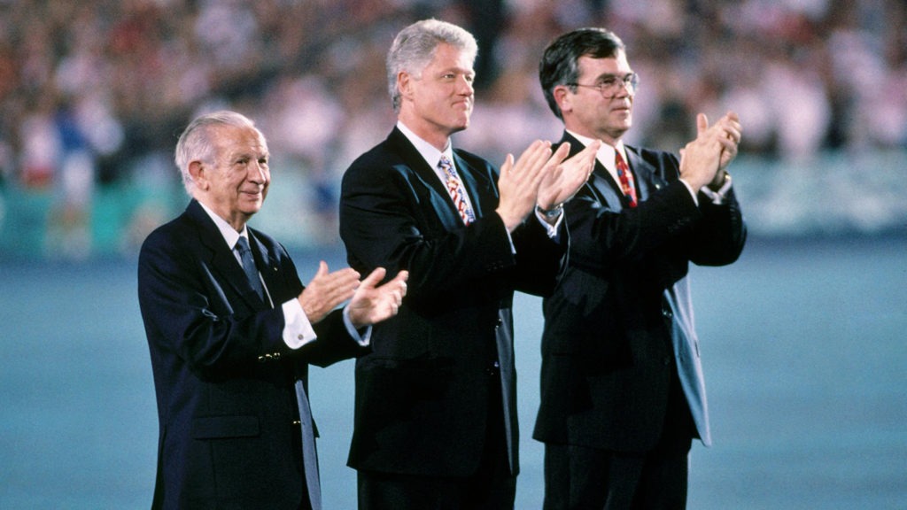 Bill Clinton is flanked the Olympic officials on the stadium floor during the Atlanta 1996 Opening Ceremony