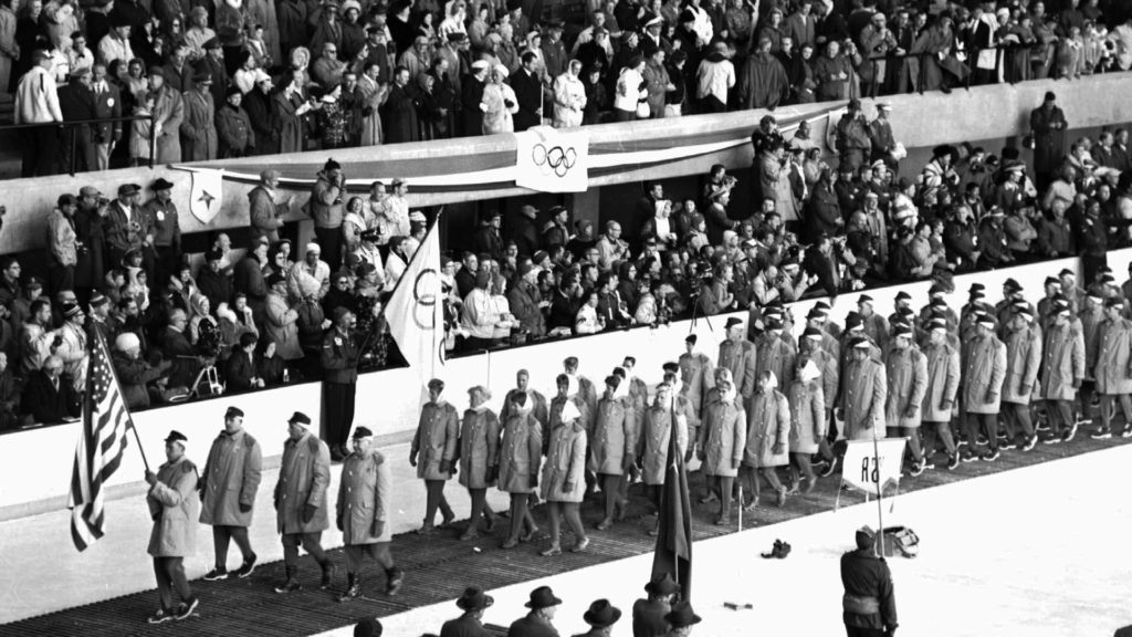 Richard Nixon is in the official reviewing stand as the U.S. delegation walks by during the Squaw Valley 1960 Opening Ceremony.