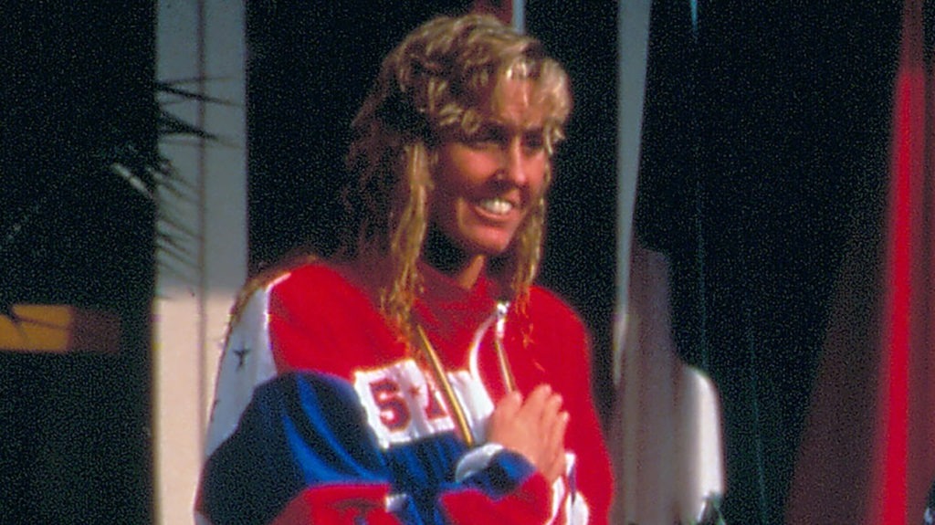 Trischa Zorn has her hand over her heart during the playing of the national anthem at a medal ceremony