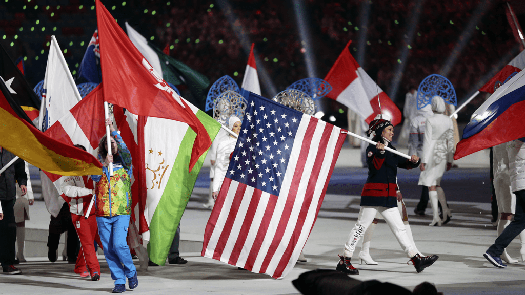 Julie Chu holds an American flag during the Sochi 2014 closing ceremony