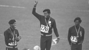 Lee Evans stands on a podium