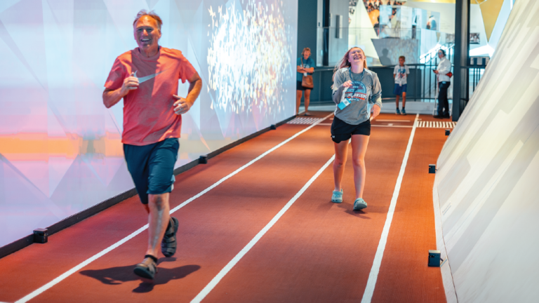 image of dad and son at interactive exhibit at the U.S. Olympic & Paralympic Museum