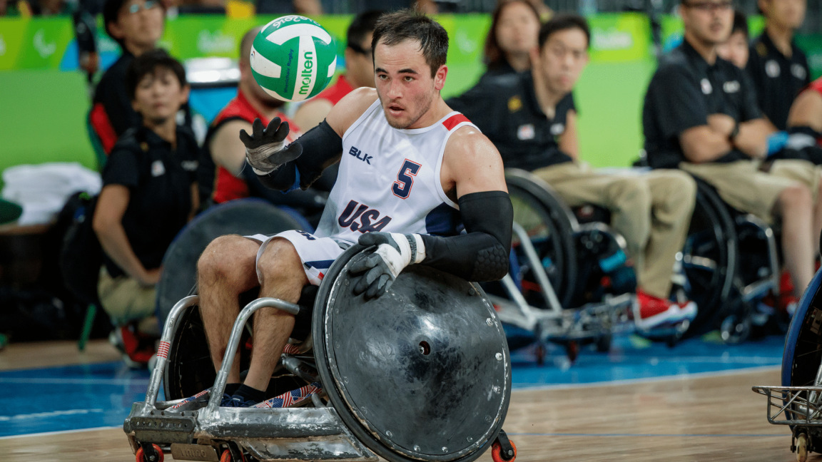 Chuck Aoki handles the ball during a wheelchair rugby match