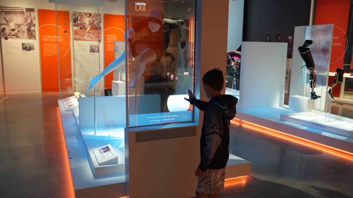 A child learning about the technology behind the speedskating track suits